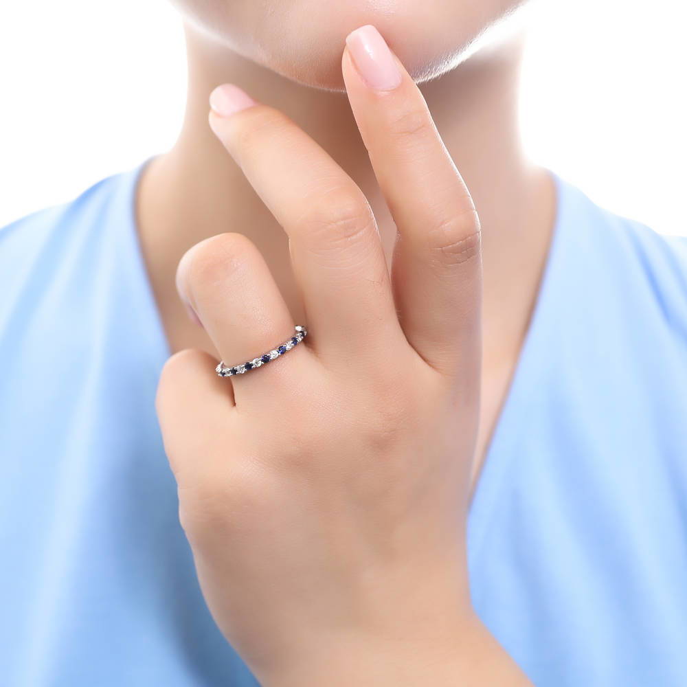 Model wearing Simulated Blue Sapphire Pave Set CZ Eternity Ring in Sterling Silver