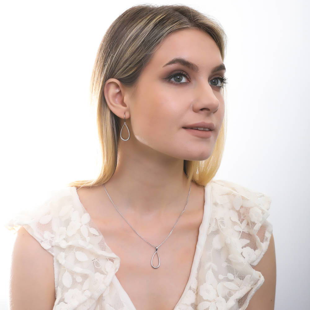 Model wearing Teardrop Fish Hook Dangle Earrings in Sterling Silver