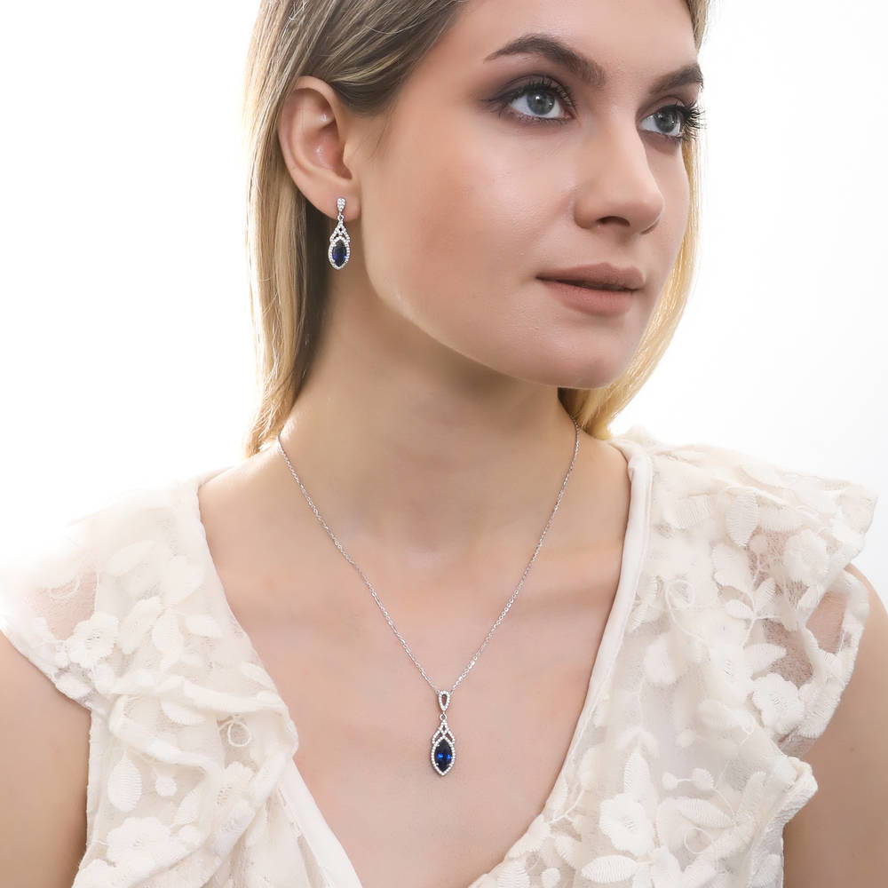 Model wearing Halo Simulated Blue Sapphire Marquise CZ Necklace in Sterling Silver, 3 of 6