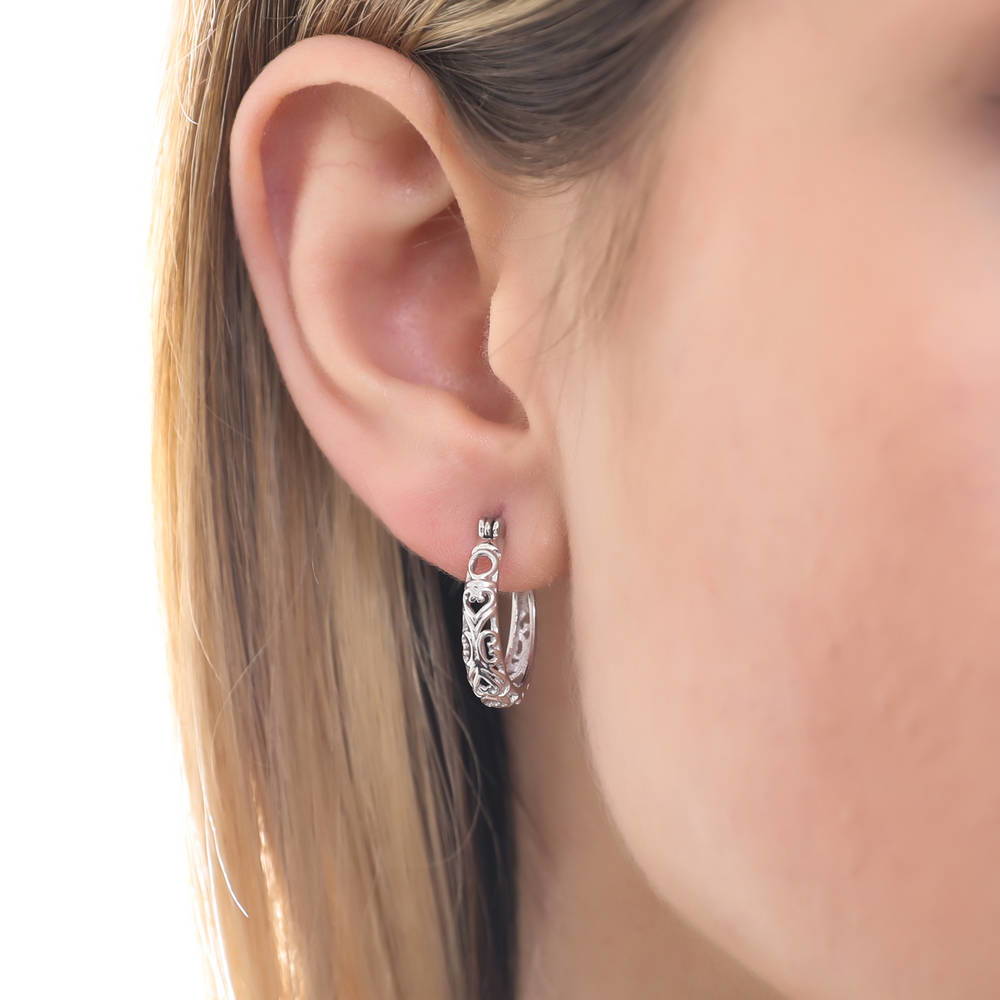 Model wearing Oval Filigree Medium Hoop Earrings in Sterling Silver 0.77 inch