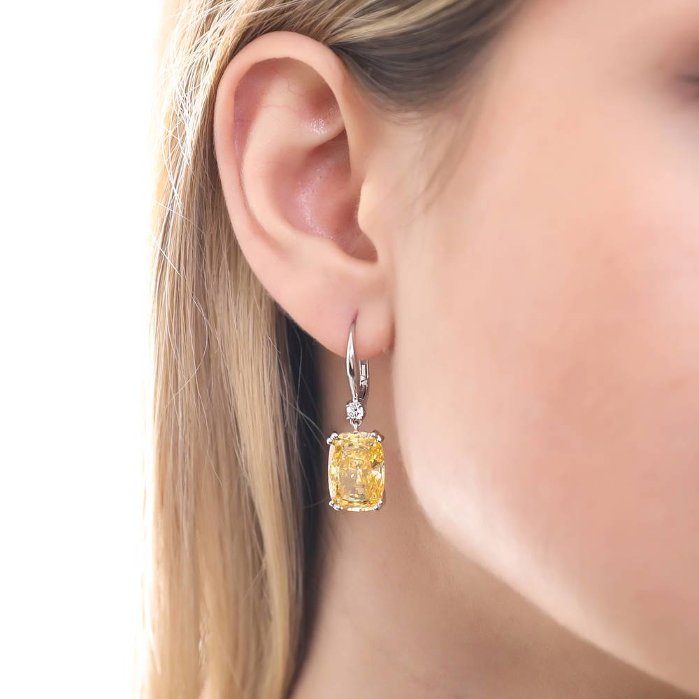 Model wearing Solitaire Canary Cushion CZ Leverback Earrings in Sterling Silver 18ct