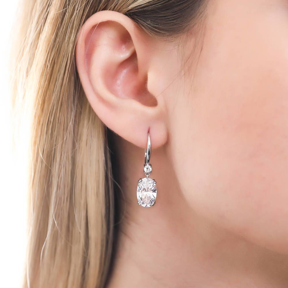 Model wearing Solitaire 6ct Oval CZ Leverback Dangle Earrings in Sterling Silver