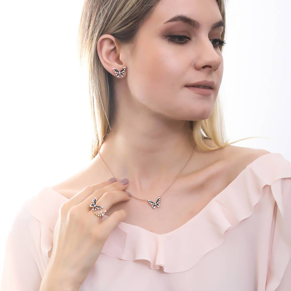 Model wearing Butterfly Enamel CZ Stud Earrings in Rose Gold Flashed Sterling Silver