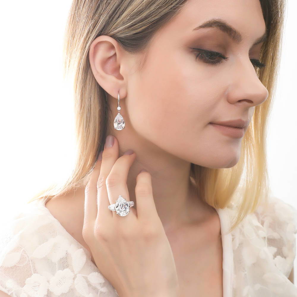 Model wearing Solitaire 11.4ct Pear CZ Leverback Dangle Earrings in Sterling Silver