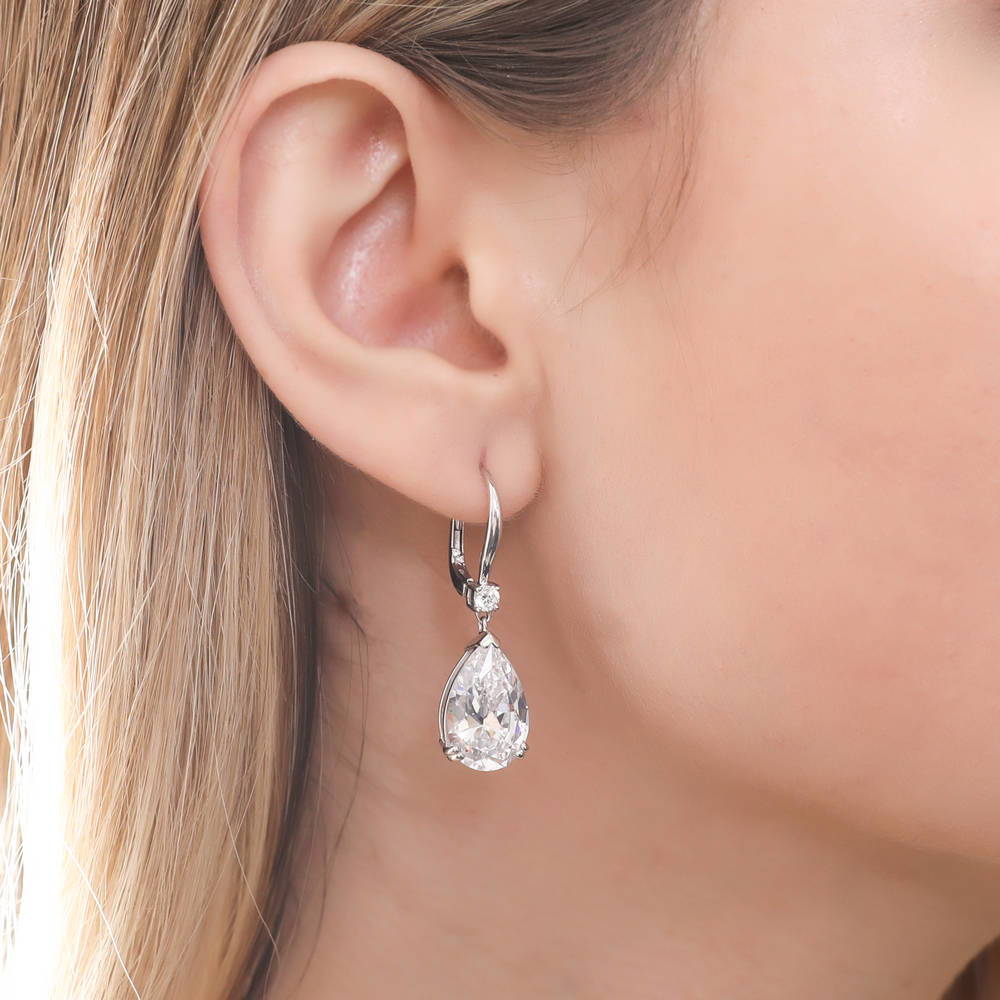 Model wearing Solitaire 11.4ct Pear CZ Leverback Dangle Earrings in Sterling Silver