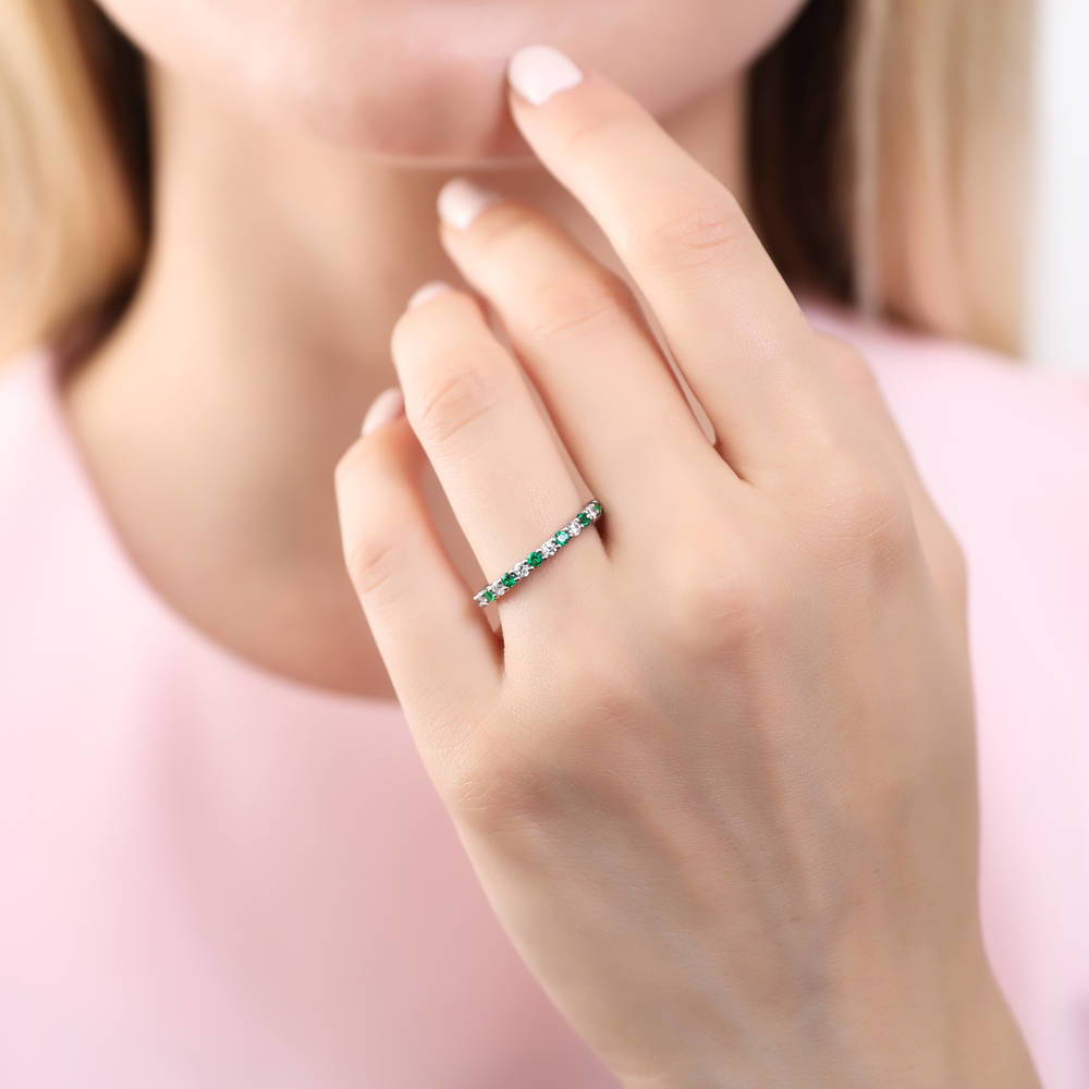 Model wearing Simulated Emerald Pave Set CZ Eternity Ring in Sterling Silver