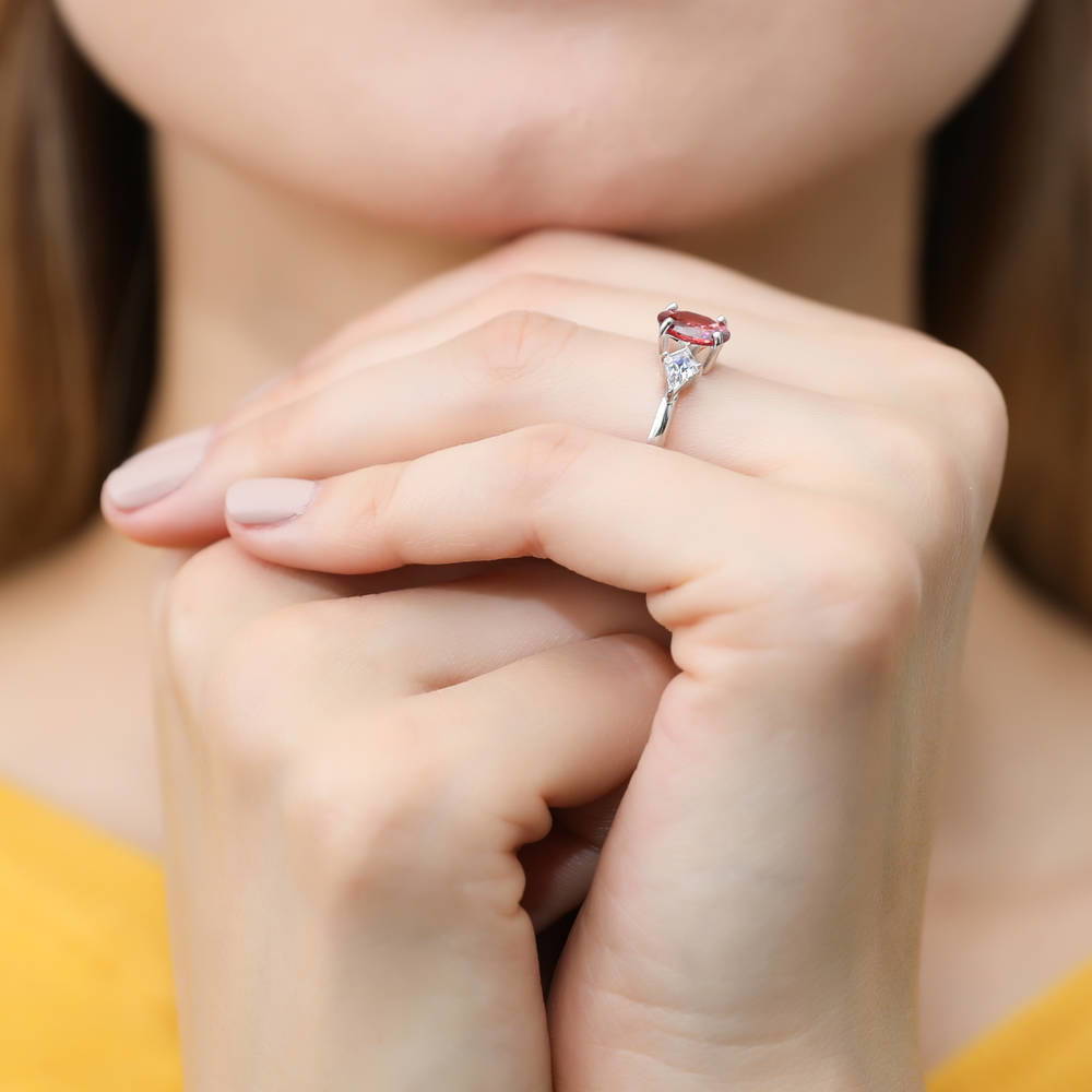 Model wearing 3-Stone Red Oval CZ Ring in Sterling Silver