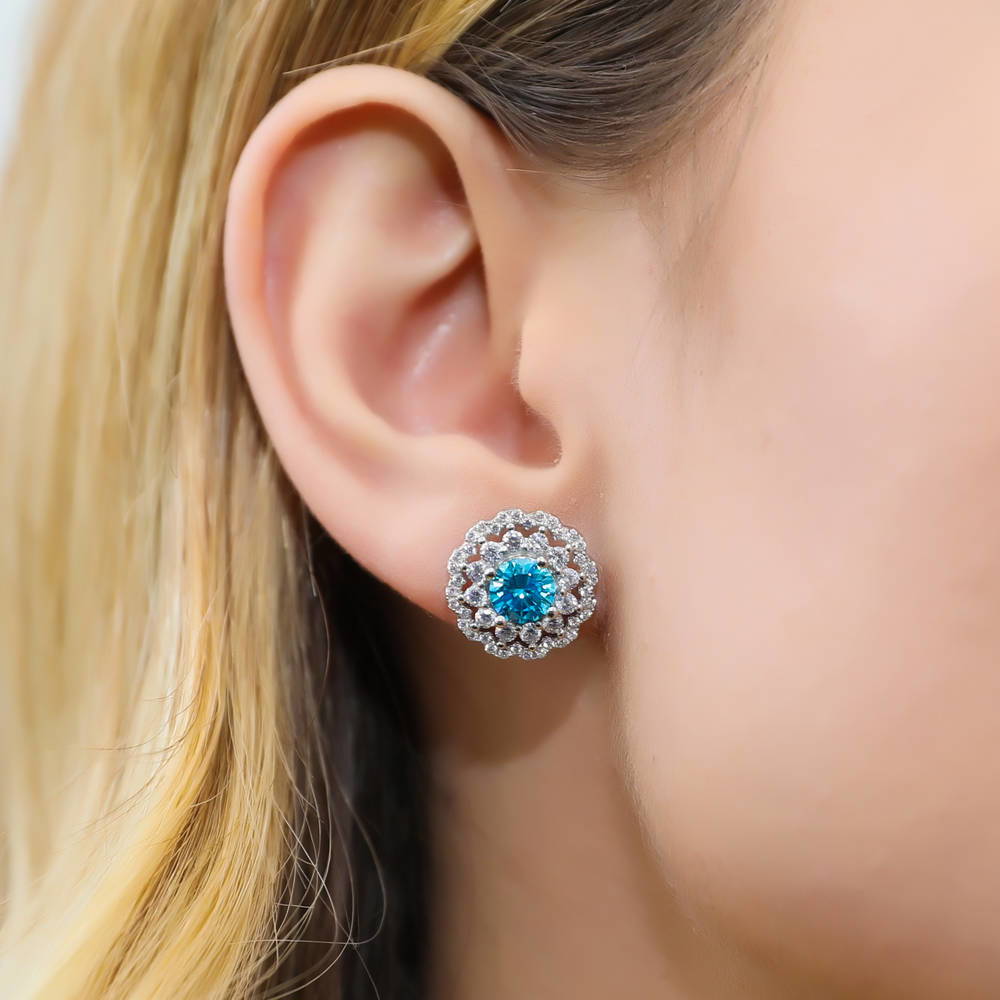 Model wearing Flower Halo Blue CZ Stud Earrings in Sterling Silver