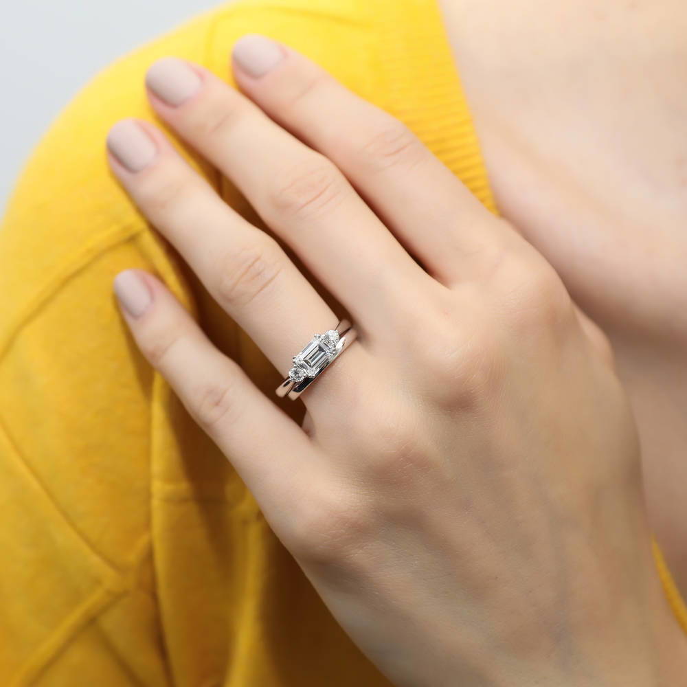 Model wearing 3-Stone East-West Emerald Cut CZ Ring Set in Sterling Silver