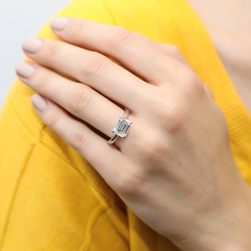 Model wearing Solitaire East-West 2.6ct Emerald Cut CZ Ring in Sterling Silver