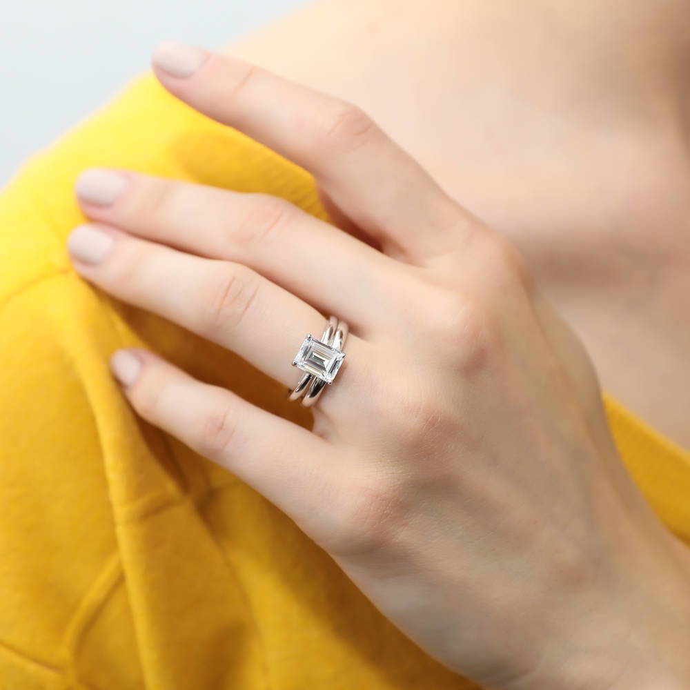 Model wearing Solitaire 2.1ct Emerald Cut CZ Ring Set in Sterling Silver
