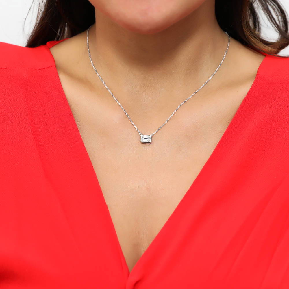 Model wearing Solitaire 1ct Bezel Set Emerald Cut CZ Necklace in Sterling Silver