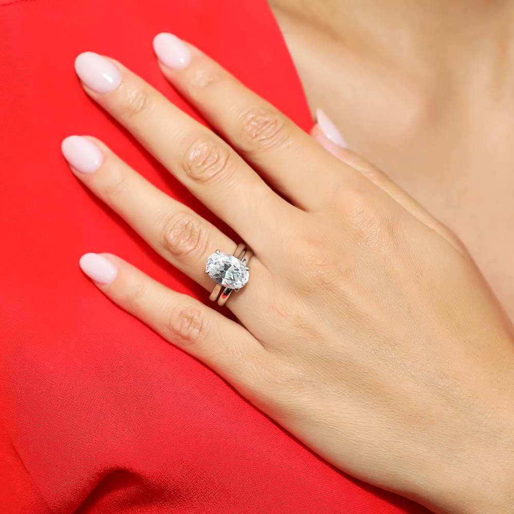 Model wearing Solitaire 5.5ct Oval CZ Ring Set in Sterling Silver