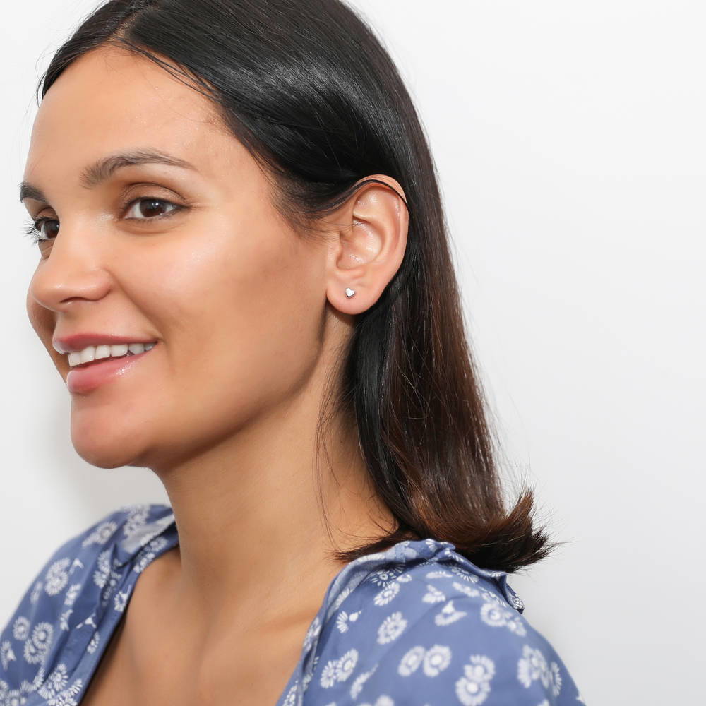 Model wearing Heart Stud Earrings in Sterling Silver