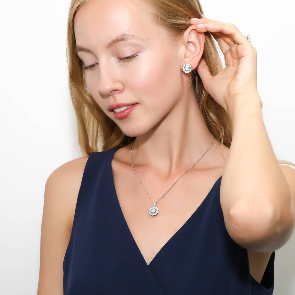 Model wearing Flower Halo CZ Omega Back Stud Earrings in Sterling Silver