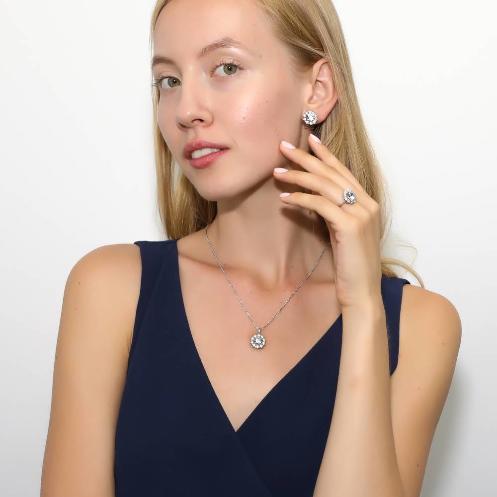 Model wearing Flower Halo CZ Omega Back Stud Earrings in Sterling Silver