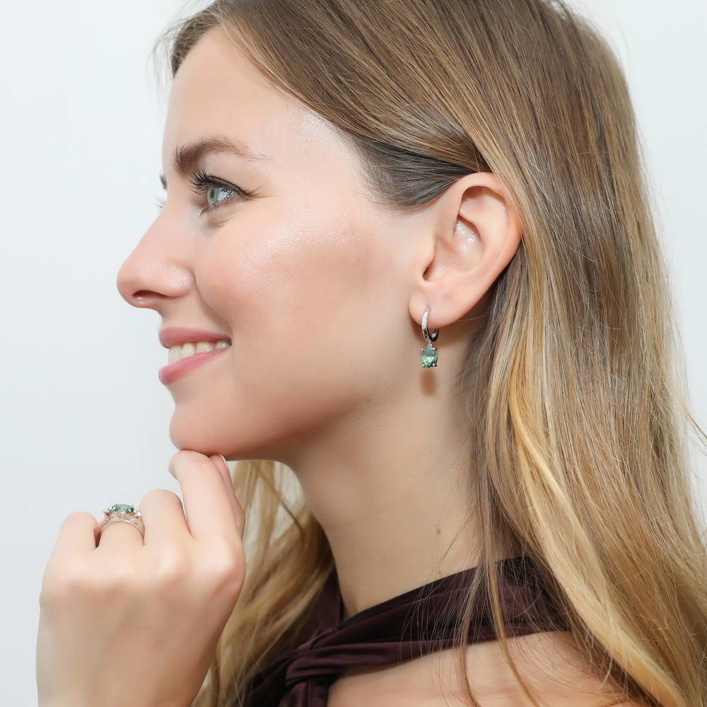 Model wearing Solitaire Green Oval CZ Dangle Earrings in Sterling Silver 2.4ct