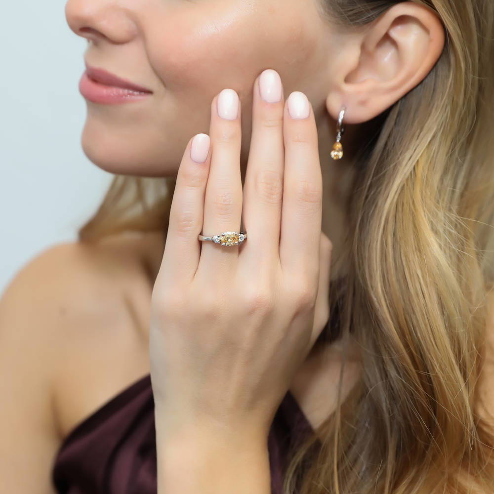 Model wearing 3-Stone East-West Yellow Oval CZ Ring in Sterling Silver, 2 of 9