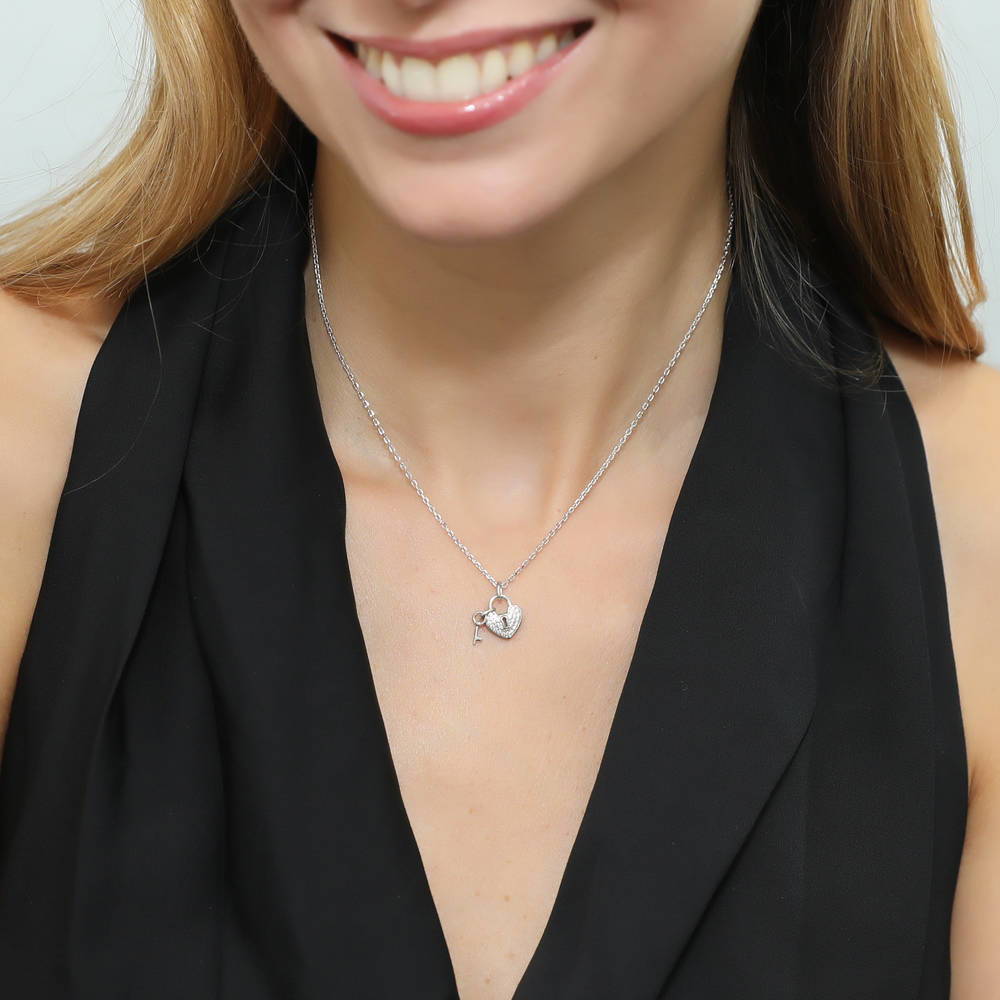 Model wearing Key and Lock Heart CZ Pendant Necklace in Sterling Silver