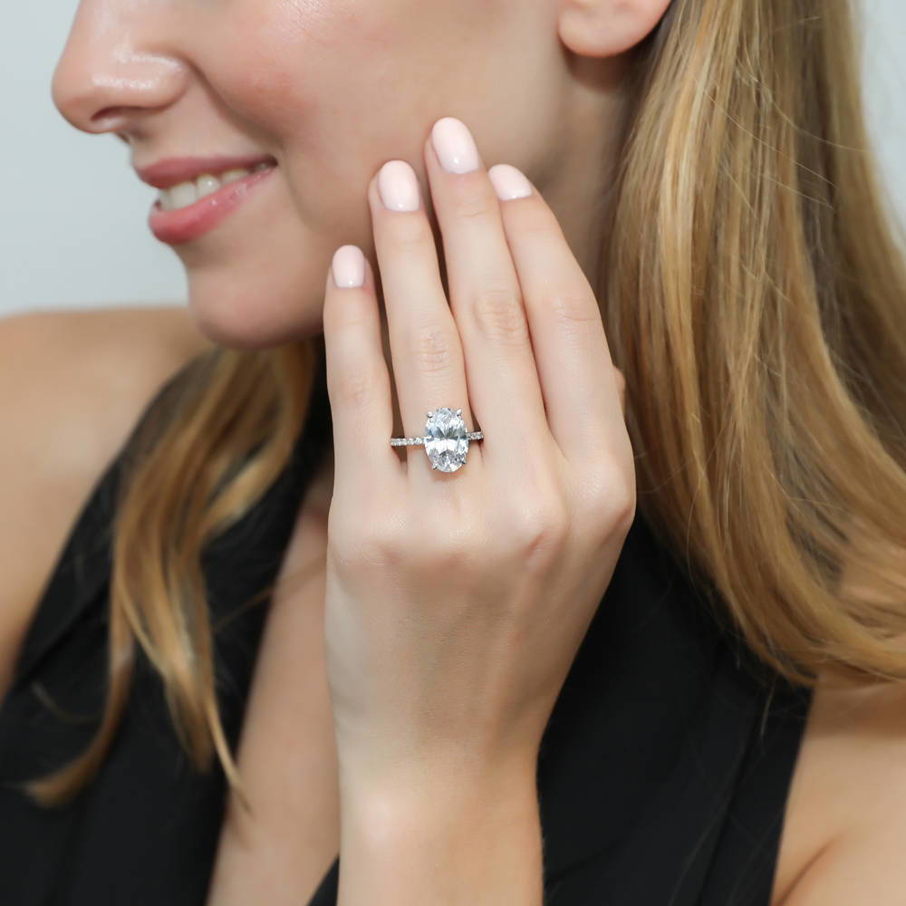 Model wearing Solitaire Hidden Halo 5.5ct Oval CZ Ring in Sterling Silver