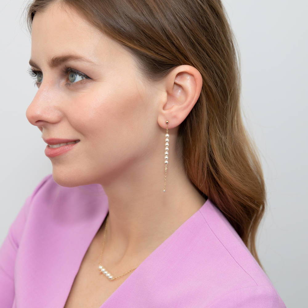 Model wearing Star Bead Imitation Pearl Earrings in Gold Flashed Sterling Silver