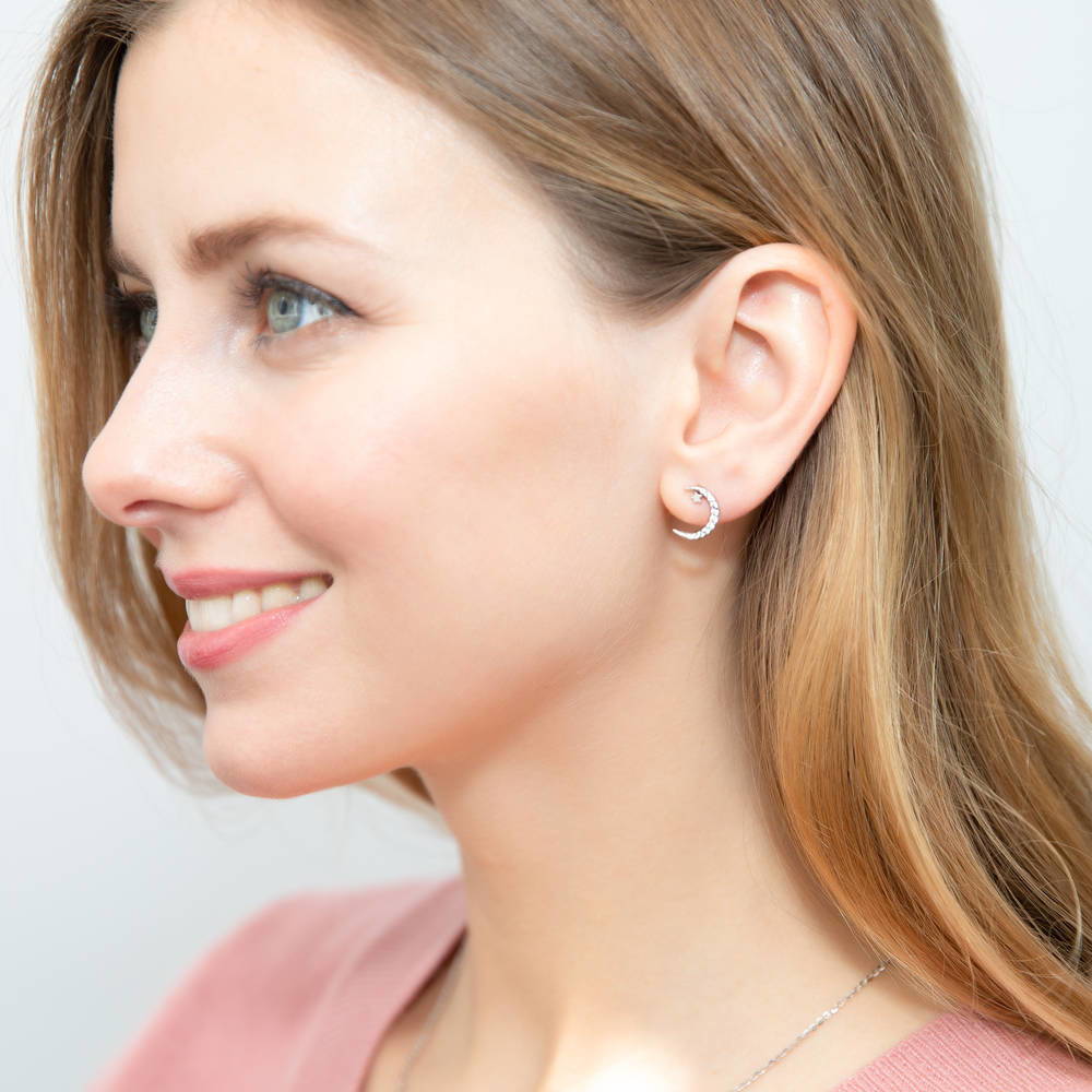 Model wearing Star Crescent Moon CZ Stud Earrings in Sterling Silver