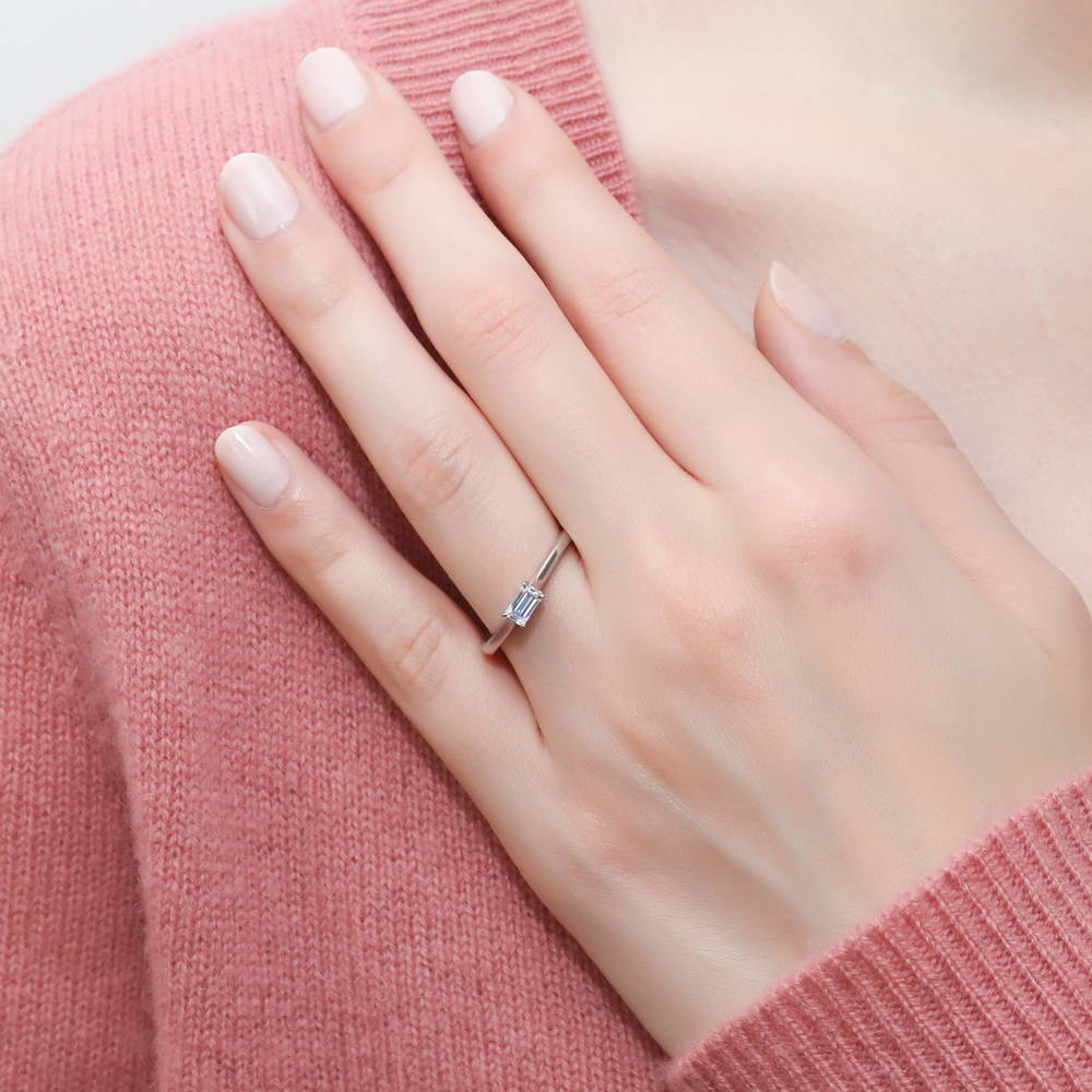 Model wearing Solitaire East-West 0.3ct Emerald Cut CZ Ring in Sterling Silver
