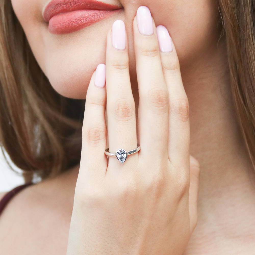Model wearing Solitaire 0.8ct Bezel Set Pear CZ Ring in Sterling Silver