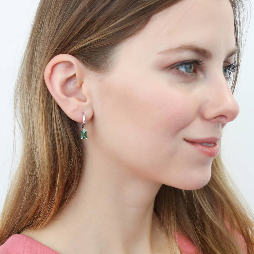 Model wearing Solitaire Emerald Cut CZ Dangle Earrings in Sterling Silver 2ct