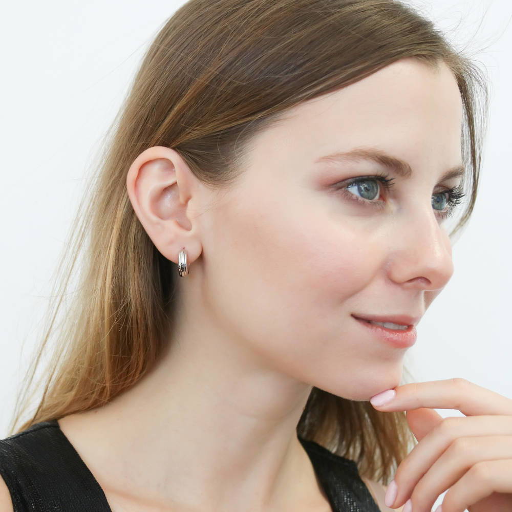 Model wearing Dome Small Huggie Earrings in Sterling Silver 0.55 inch