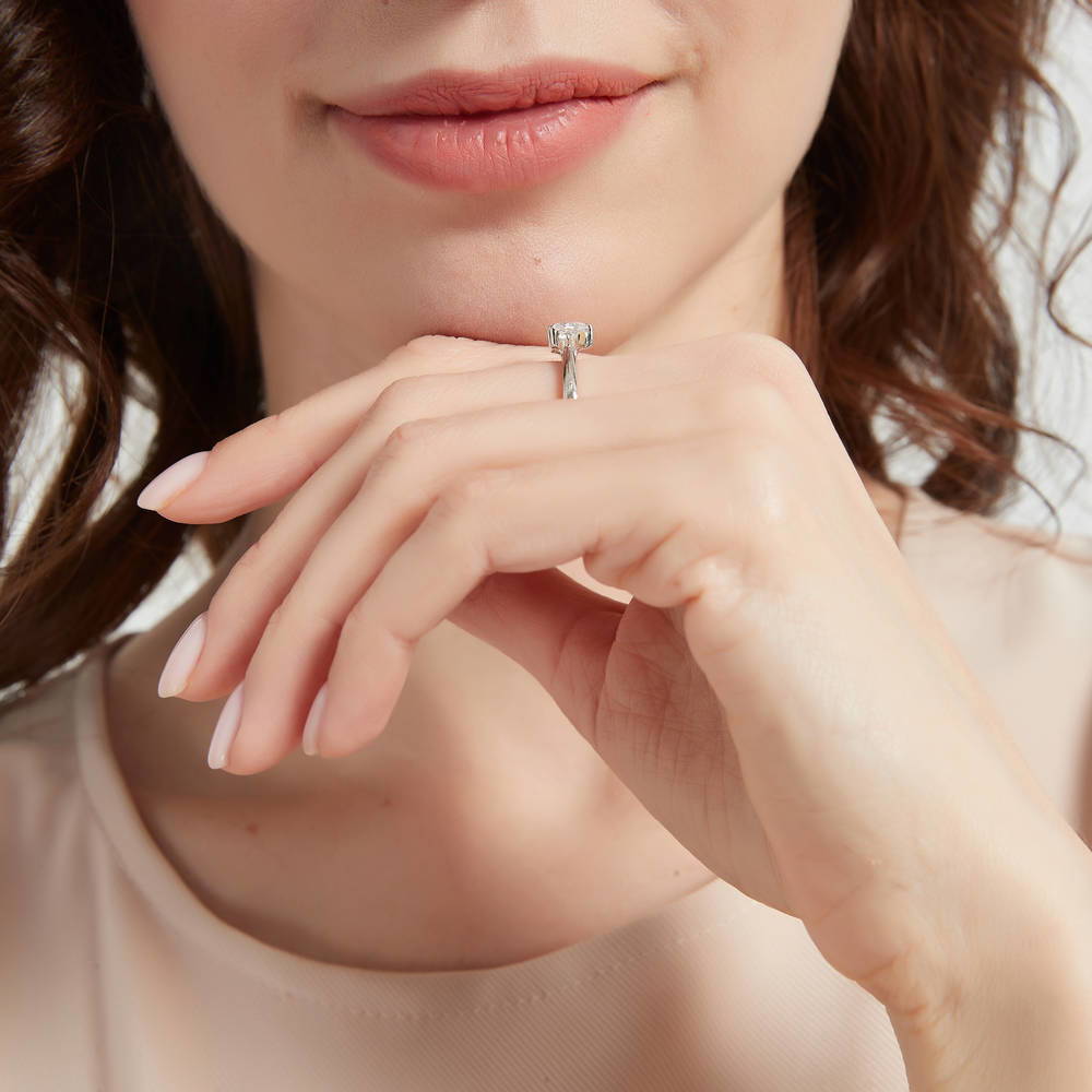 Model wearing 3-Stone Heart CZ Ring in Sterling Silver