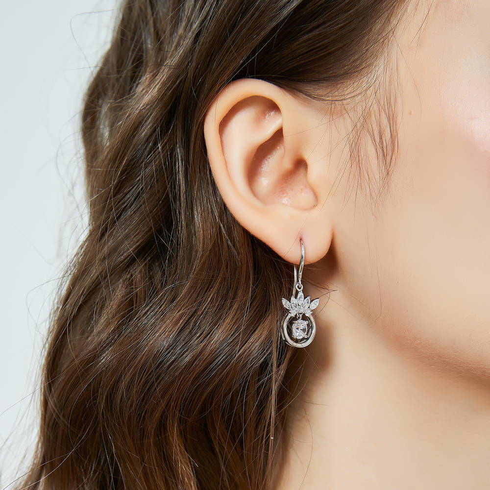 Model wearing Crown Solitaire CZ Fish Hook Dangle Earrings in Sterling Silver