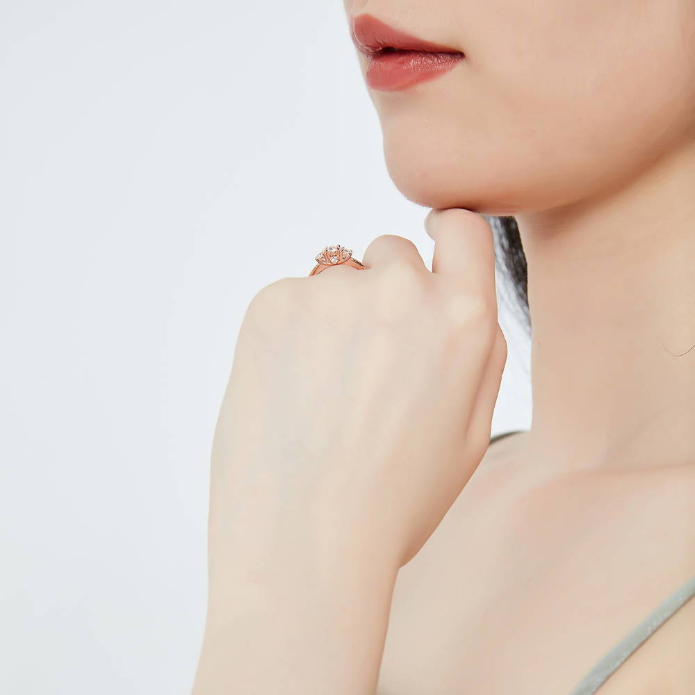 Model wearing 3-Stone Round CZ Ring in Rose Gold Plated Sterling Silver
