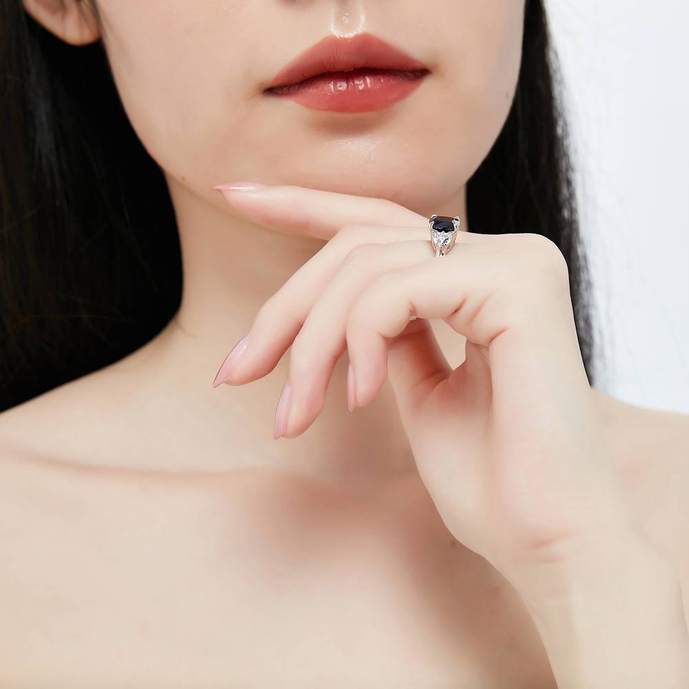 Model wearing 3-Stone Simulated Blue Sapphire Cushion CZ Ring in Sterling Silver