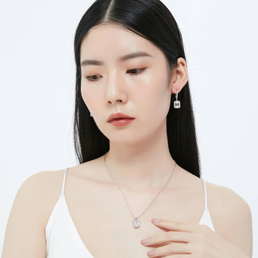 Model wearing Halo Emerald Cut CZ Necklace and Earrings Set in Sterling Silver