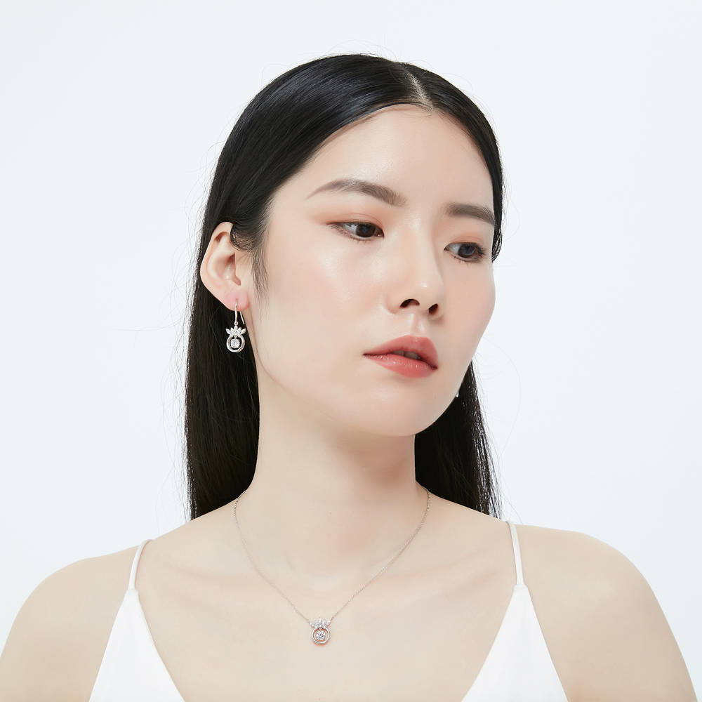 Model wearing Crown Solitaire CZ Fish Hook Dangle Earrings in Sterling Silver