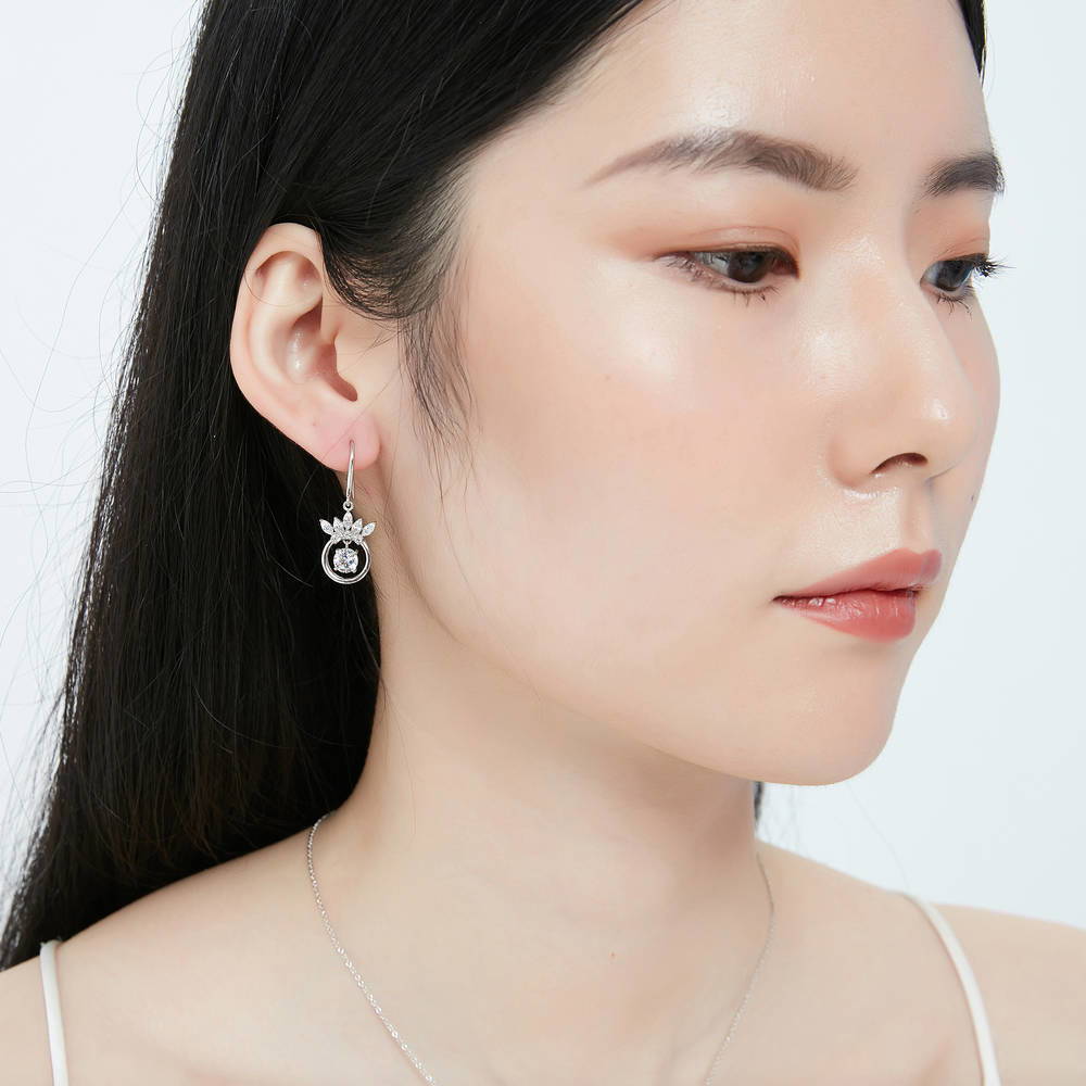 Model wearing Crown Solitaire CZ Fish Hook Dangle Earrings in Sterling Silver