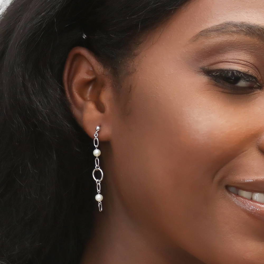Model wearing Open Circle White Round Cultured Pearl Earrings in Sterling Silver