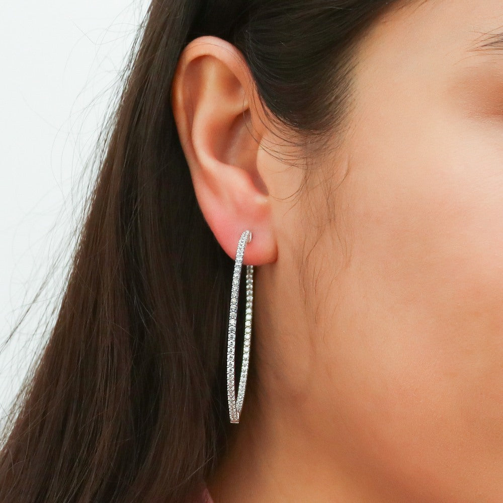 Model wearing CZ Large Inside-Out Hoop Earrings in Sterling Silver 2 inch