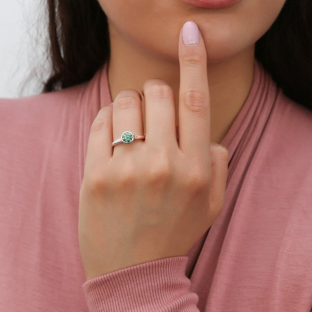 Model wearing Solitaire 0.8ct Green Bezel Set Round CZ Ring Set in Sterling Silver, 2 of 10
