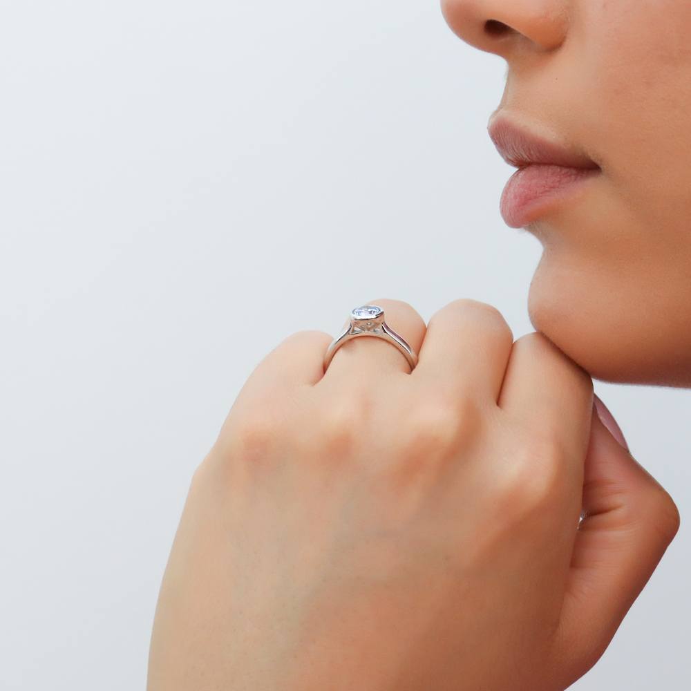 Model wearing Solitaire Greyish Blue Bezel Set Round CZ Ring in Sterling Silver 0.8ct, 2 of 9