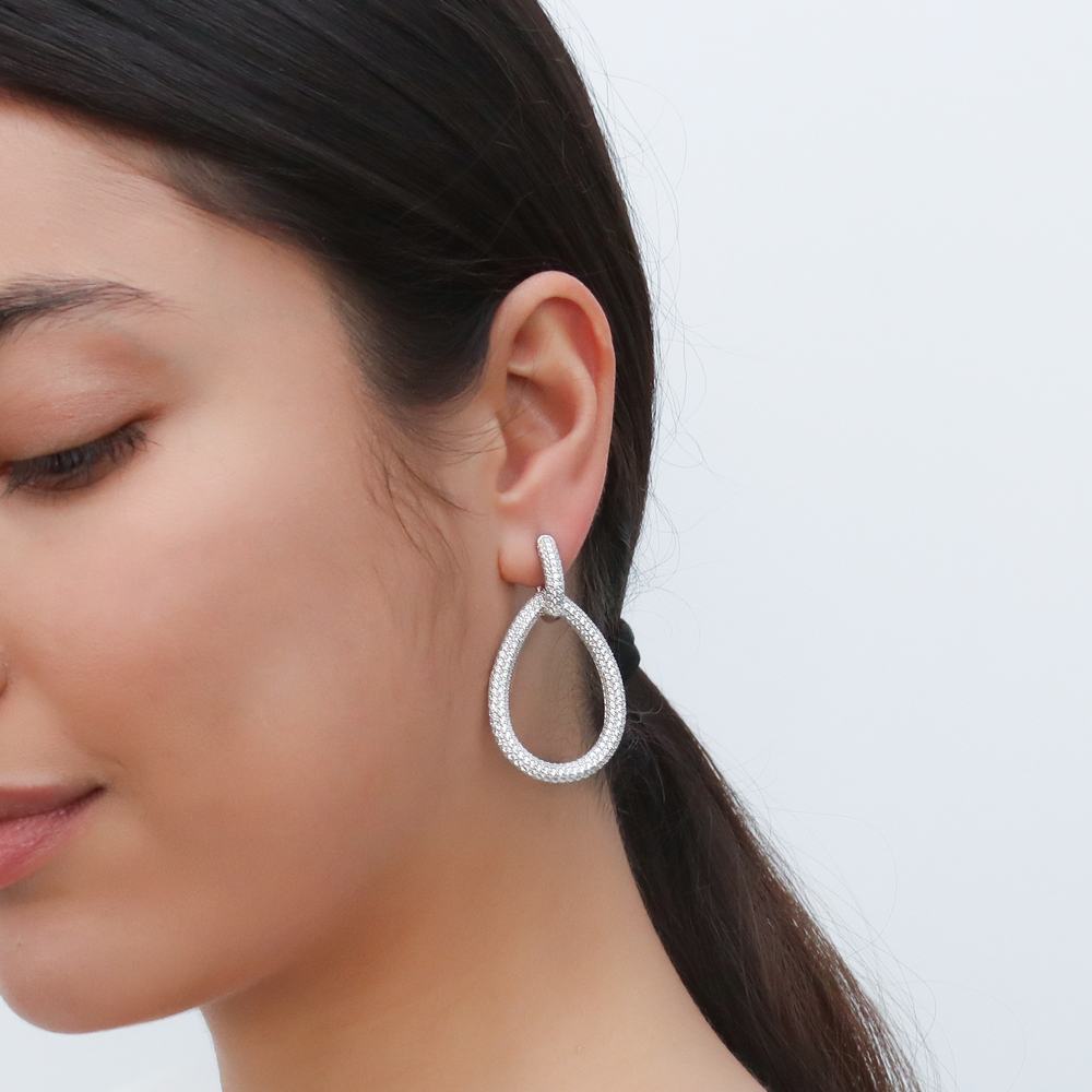 Model wearing Teardrop CZ Statement Dangle Earrings in Sterling Silver