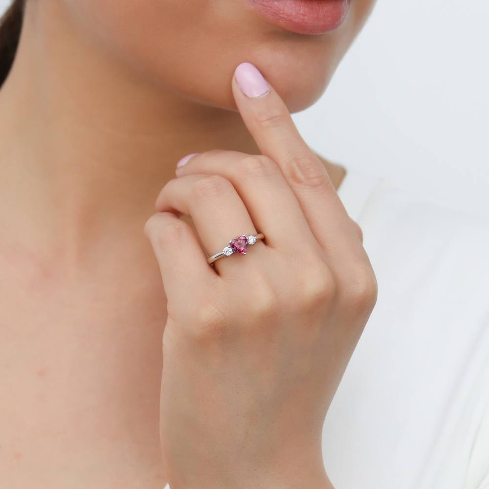 Model wearing 3-Stone Heart Red CZ Ring in Sterling Silver