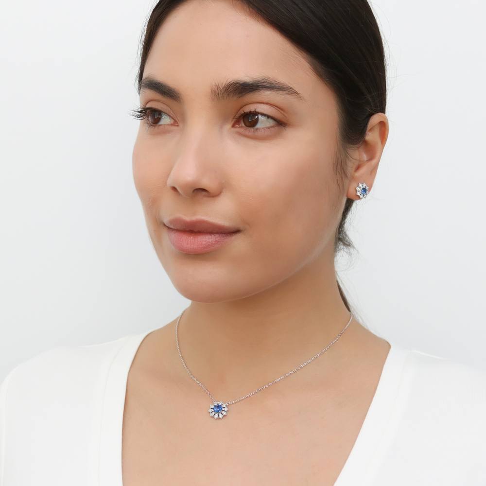 Model wearing Halo Flower Blue Round CZ Pendant Necklace in Sterling Silver