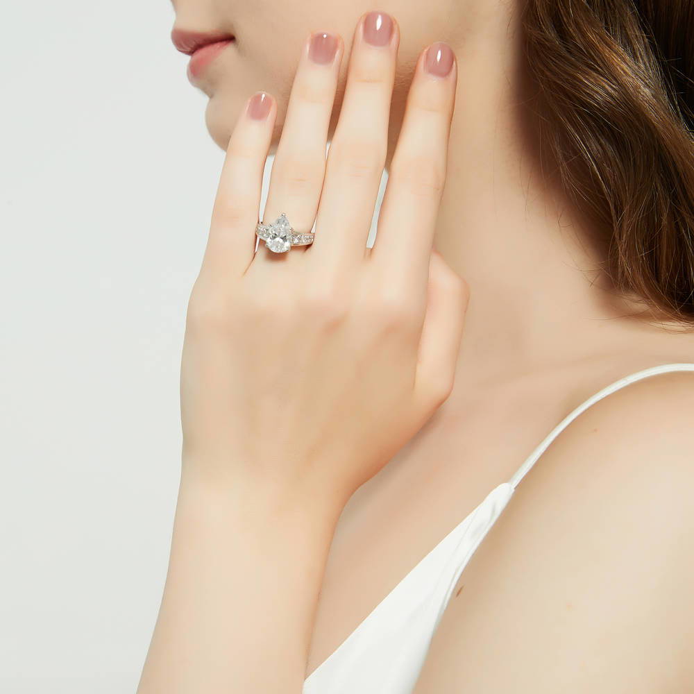 Model wearing Solitaire 3ct Pear CZ Ring Set in Sterling Silver, 9 of 18