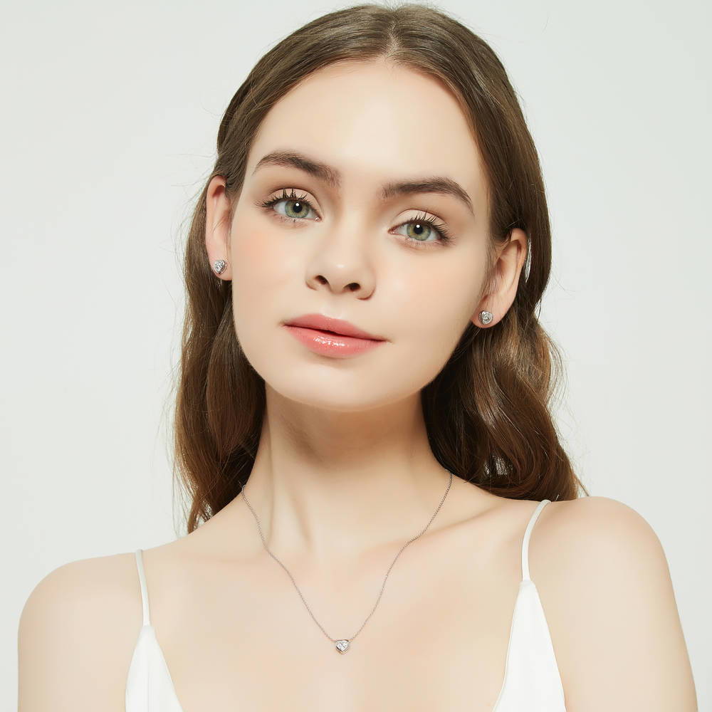Model wearing Solitaire Bezel Set Heart CZ Pendant Necklace in Sterling Silver 0.7ct, 3 of 6