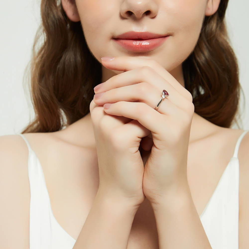 Model wearing 3-Stone Heart Red CZ Ring in Sterling Silver