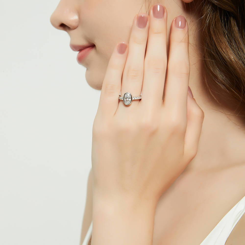 Model wearing Solitaire 1.4ct Bezel Set Oval CZ Ring in Sterling Silver