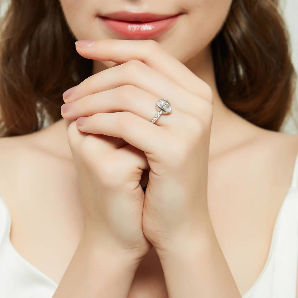 Model wearing Solitaire 1.4ct Bezel Set Oval CZ Ring in Sterling Silver