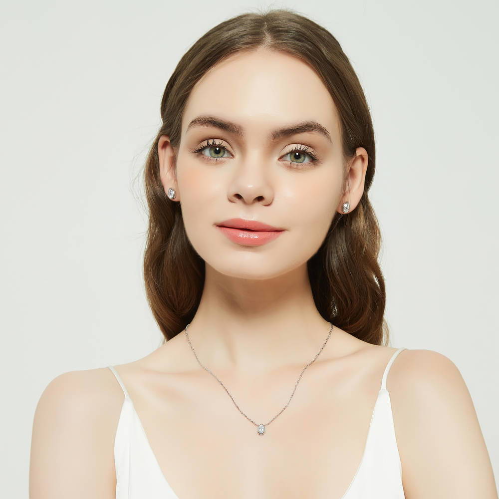 Model wearing Solitaire Bezel Set Pear CZ Pendant Necklace in Sterling Silver 0.8ct, 3 of 6